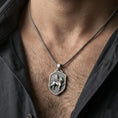 Load image into Gallery viewer, Sterling silver winged lion shield pendant necklace worn on the neck, close-up lifestyle shot highlighting the oxidized finish and raised heraldic emblem
