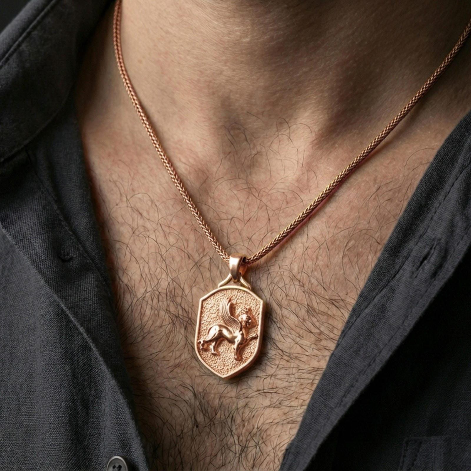 Sterling silver winged lion crest pendant necklace on the neck, macro lifestyle shot showcasing the rose gold plated finish and textured shield background