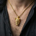 Load image into Gallery viewer, Sterling silver oni mask pendant worn on the neck, close-up lifestyle photo featuring the gold plated finish and fierce horned face details
