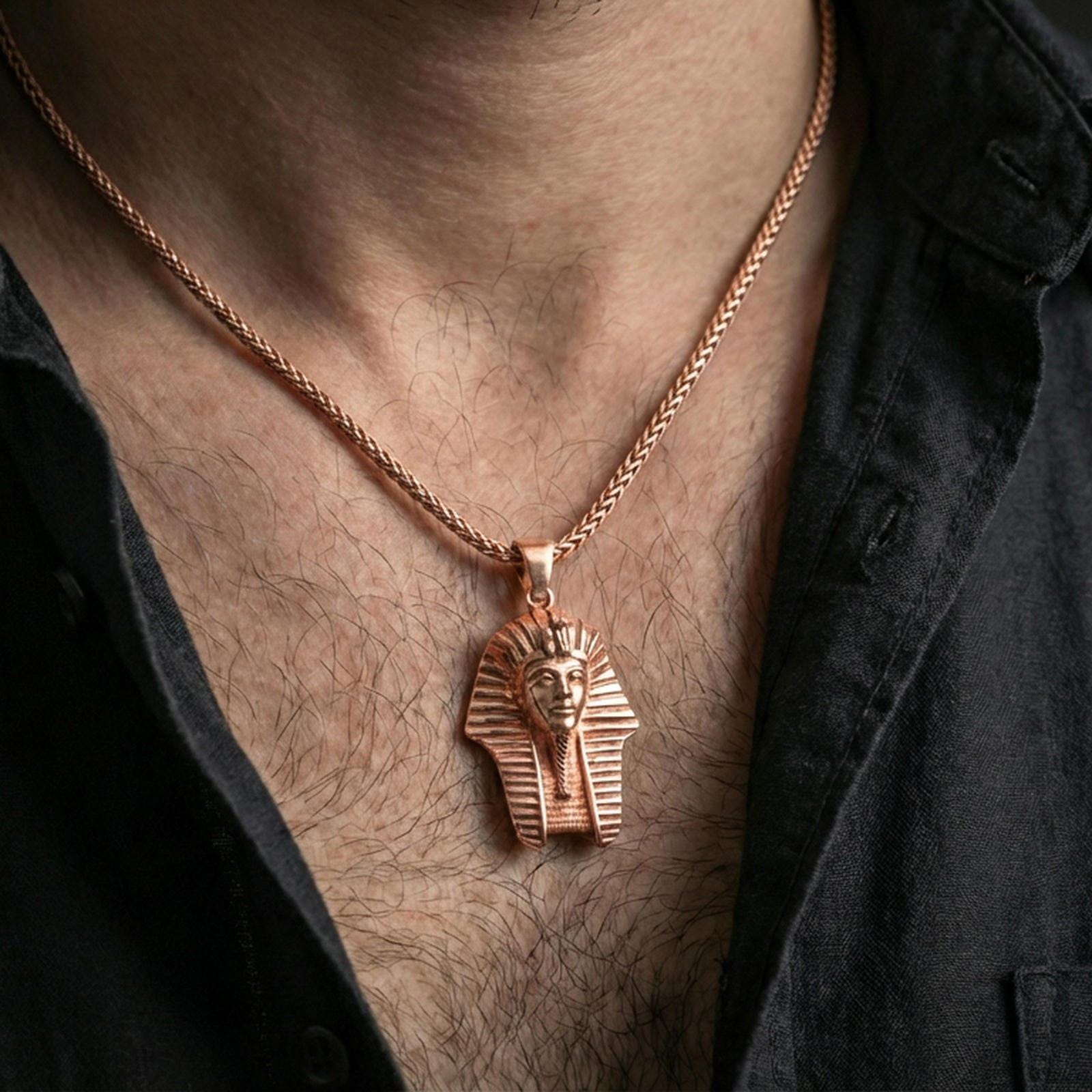 Sterling silver pharaoh head pendant necklace on the neck, macro lifestyle shot showcasing the rose gold plated finish and high-relief pharaoh design