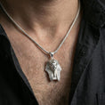 Load image into Gallery viewer, Sterling silver pharaoh head pendant necklace on the neck, macro lifestyle image showing the polished silver finish and sharp facial sculpting
