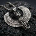 Load image into Gallery viewer, Sterling silver winged cat pendant inspired by Egyptian Bastet with an oxidized finish, detailed feather wings and feline body relief, close-up on black volcanic rock
