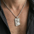 Load image into Gallery viewer, Polished silver Loki pendant necklace worn on the neck, clean lifestyle wear shot capturing bright reflections and the detailed Norse mythology design.
