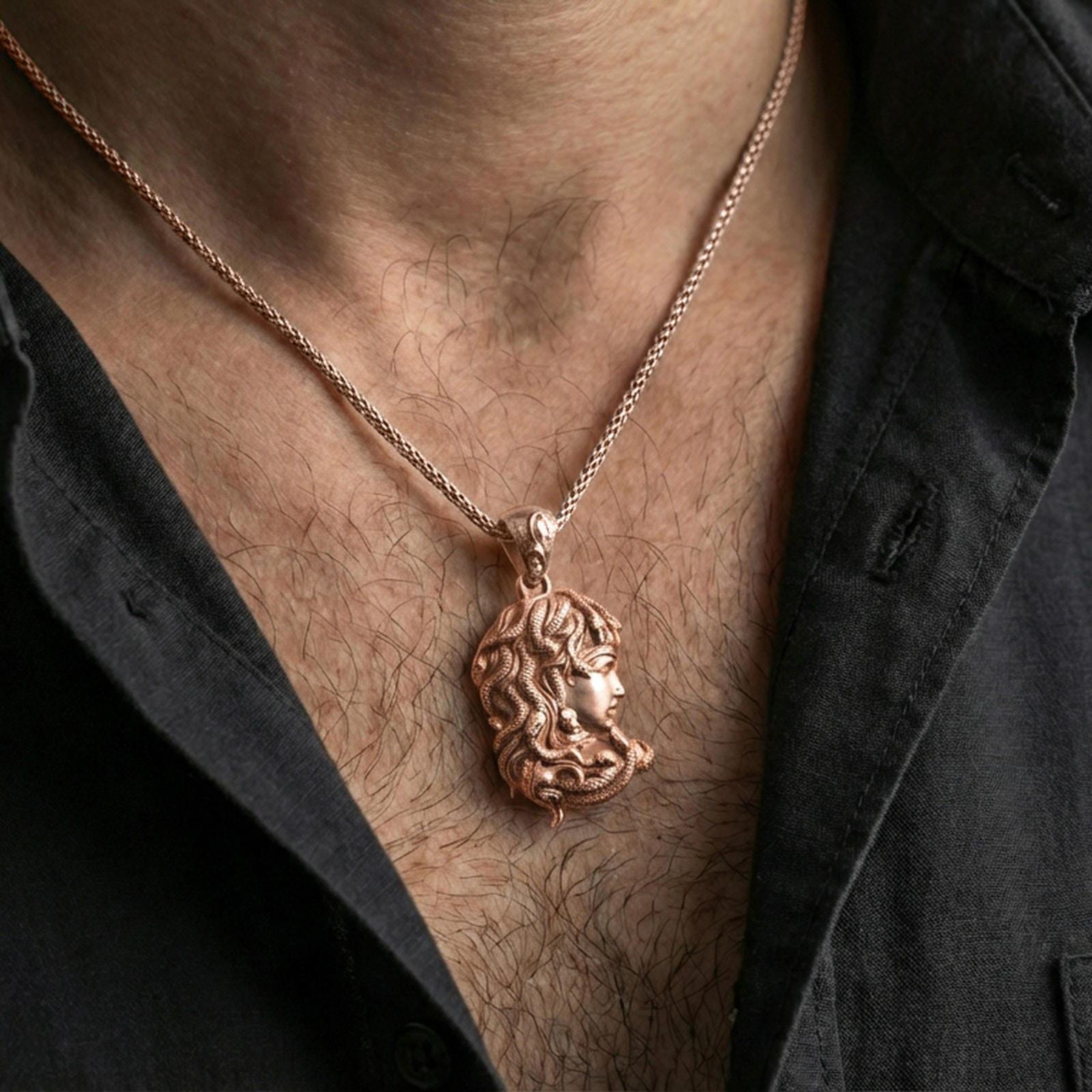 Rose gold plated Medusa profile pendant necklace worn on the neck, lifestyle wear shot with elegant rosy shine and crisp gorgon profile relief.