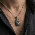 Load image into Gallery viewer, Oxidized Medusa profile pendant necklace worn on the neck, lifestyle framing showing realistic scale and bold vintage contrast against the chest.
