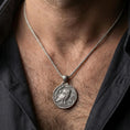 Load image into Gallery viewer, Oxidized owl coin pendant necklace worn on the neck, lifestyle framing showing realistic scale and bold vintage contrast against the chest.
