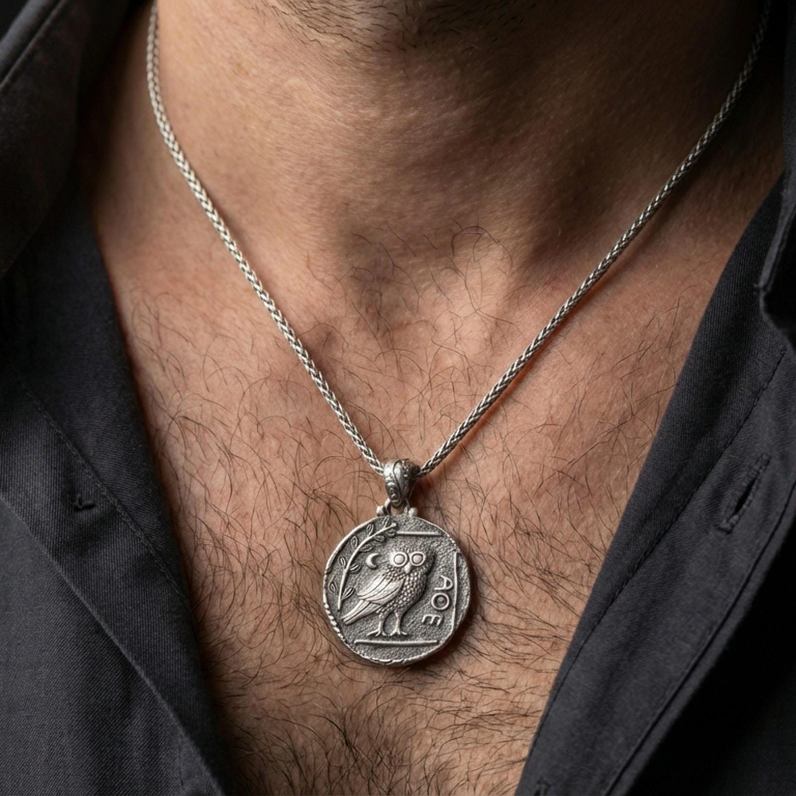 Oxidized owl coin pendant necklace worn on the neck, lifestyle framing showing realistic scale and bold vintage contrast against the chest.