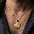 Load image into Gallery viewer, Gold plated owl coin pendant necklace worn on the neck, lifestyle photo featuring warm tone finish and strong statement coin pendant presence.
