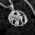 Load image into Gallery viewer, Polished silver griffin pendant necklace on textured volcanic rock, crisp macro product photo emphasizing clean edges, sharp feather lines, and detailed lion body sculpting.
