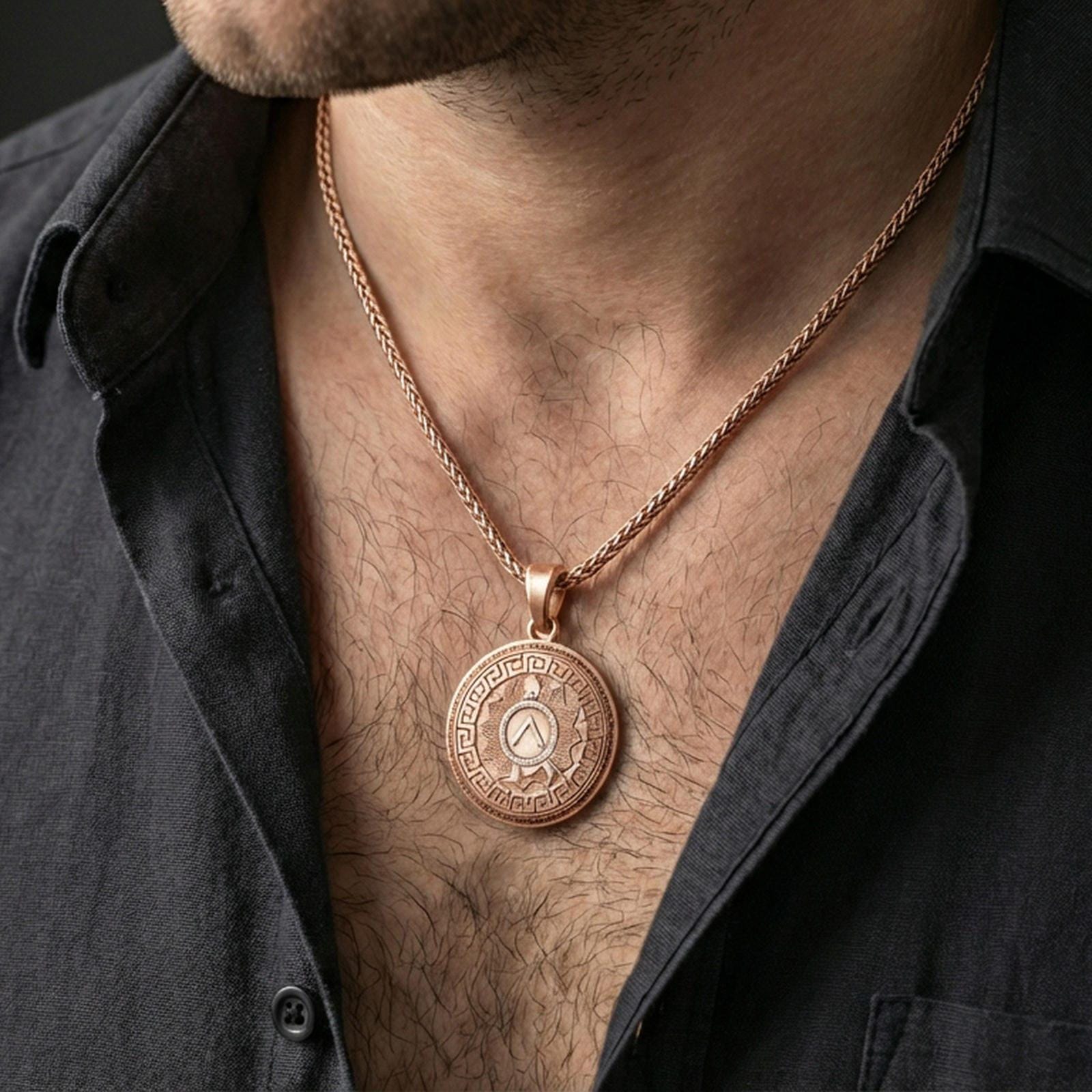 Rose gold plated Spartan shield medallion pendant necklace worn on the neck, lifestyle wear shot with elegant rosy shine and crisp geometric shield detailing visible.
