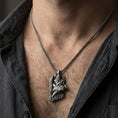 Load image into Gallery viewer, Oxidized Njord Norse sea god pendant necklace worn on the neck, lifestyle framing showing realistic scale and bold vintage contrast against the chest.
