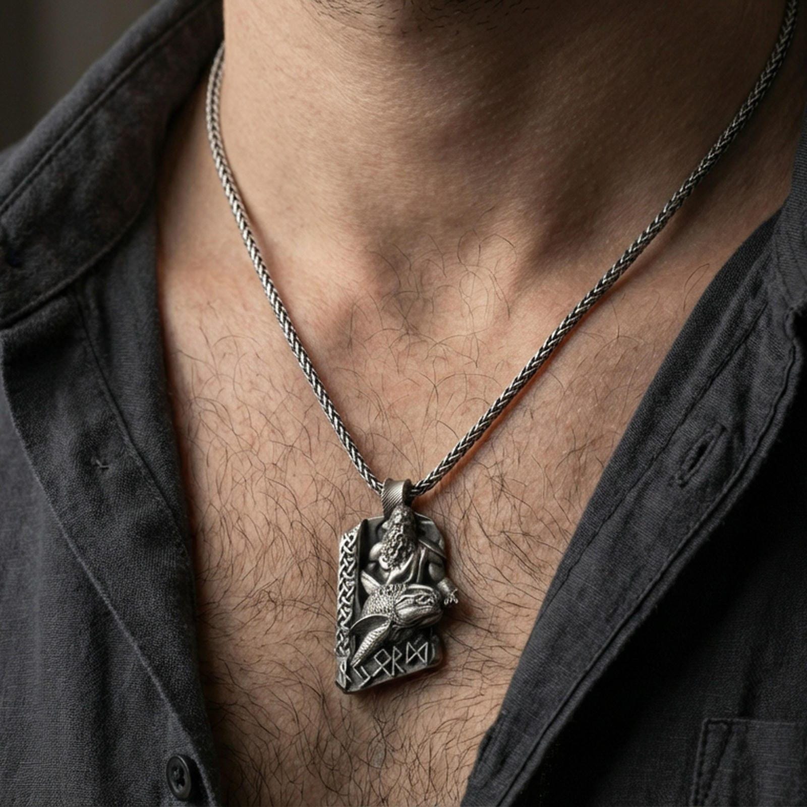 Oxidized Njord Norse sea god pendant necklace worn on the neck, lifestyle framing showing realistic scale and bold vintage contrast against the chest.