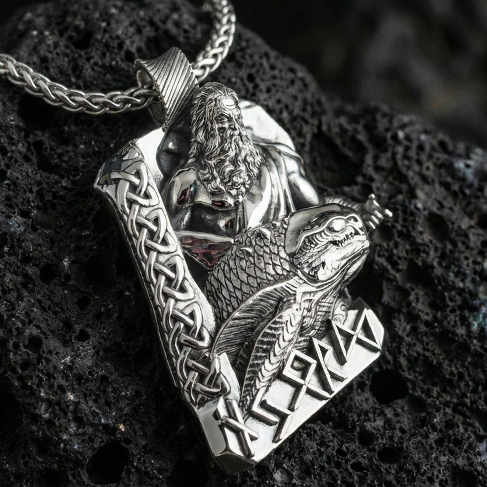 Polished silver Njord Norse sea god pendant necklace on textured volcanic rock, crisp macro product photo emphasizing sharp sculpted details, clean edges, and the engraved runes at the bottom.