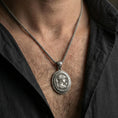 Load image into Gallery viewer, Oxidized Athena coin pendant necklace worn on the neck, lifestyle framing showing realistic scale and bold vintage contrast against the chest.
