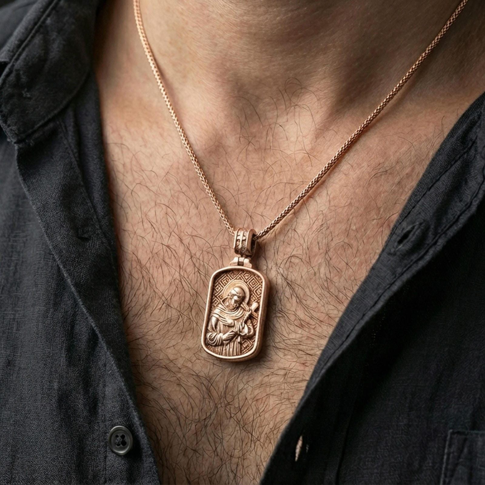 Rose gold plated Catholic Saint Francis pendant worn on the neck in a refined lifestyle shot with a warm and elegant presentation