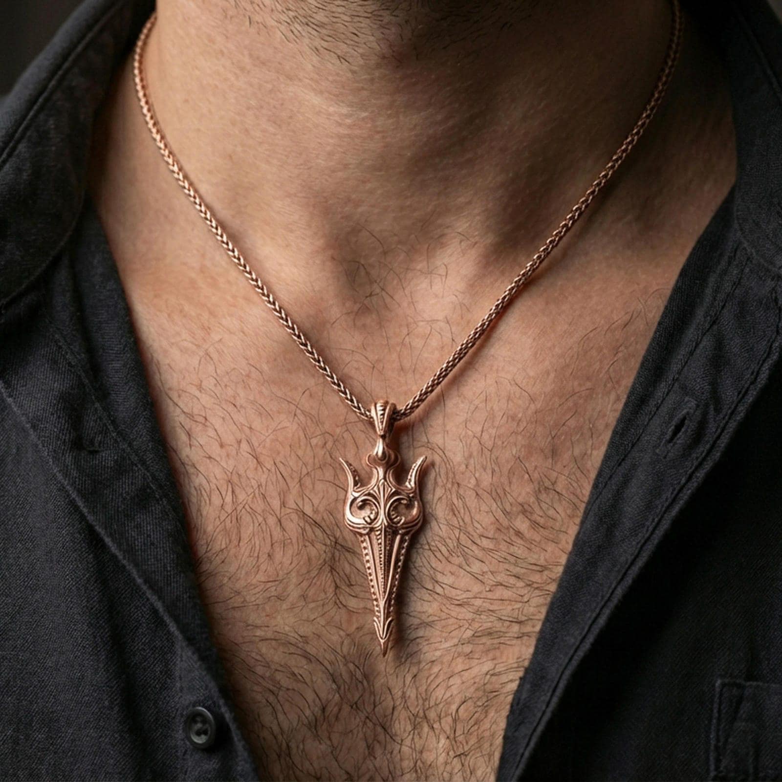 Rose gold plated Gungnir spear pendant necklace worn on the neck, lifestyle wear shot with elegant rosy shine and crisp engraved spear detailing visible.