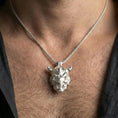 Load image into Gallery viewer, Polished silver oni mask pendant necklace worn on the neck, clean lifestyle wear shot capturing bright shine and the detailed horn-and-fang relief in natural light.
