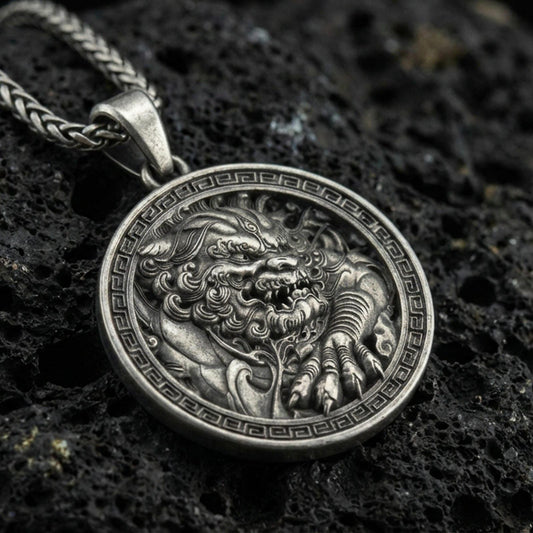 Oxidized imperial guardian lion pendant necklace on textured volcanic rock, centered close-up highlighting the fierce fu dog face, paw detail, and deep antique shadowed contrast within the Greek key frame.