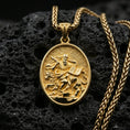 Load image into Gallery viewer, Gold plated saint medal pendant with detailed devotional figure, lion companion, and sacred scripture design showcased on black volcanic rock in a refined macro jewelry image
