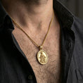 Load image into Gallery viewer, Gold plated Saint Rochus necklace with staff and dog motif worn on the neck in a premium lifestyle composition with classic devotional jewelry styling
