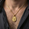 Load image into Gallery viewer, Gold plated Christian resurrection necklace with risen Christ motif worn on the neck in a premium lifestyle composition with timeless devotional jewelry styling
