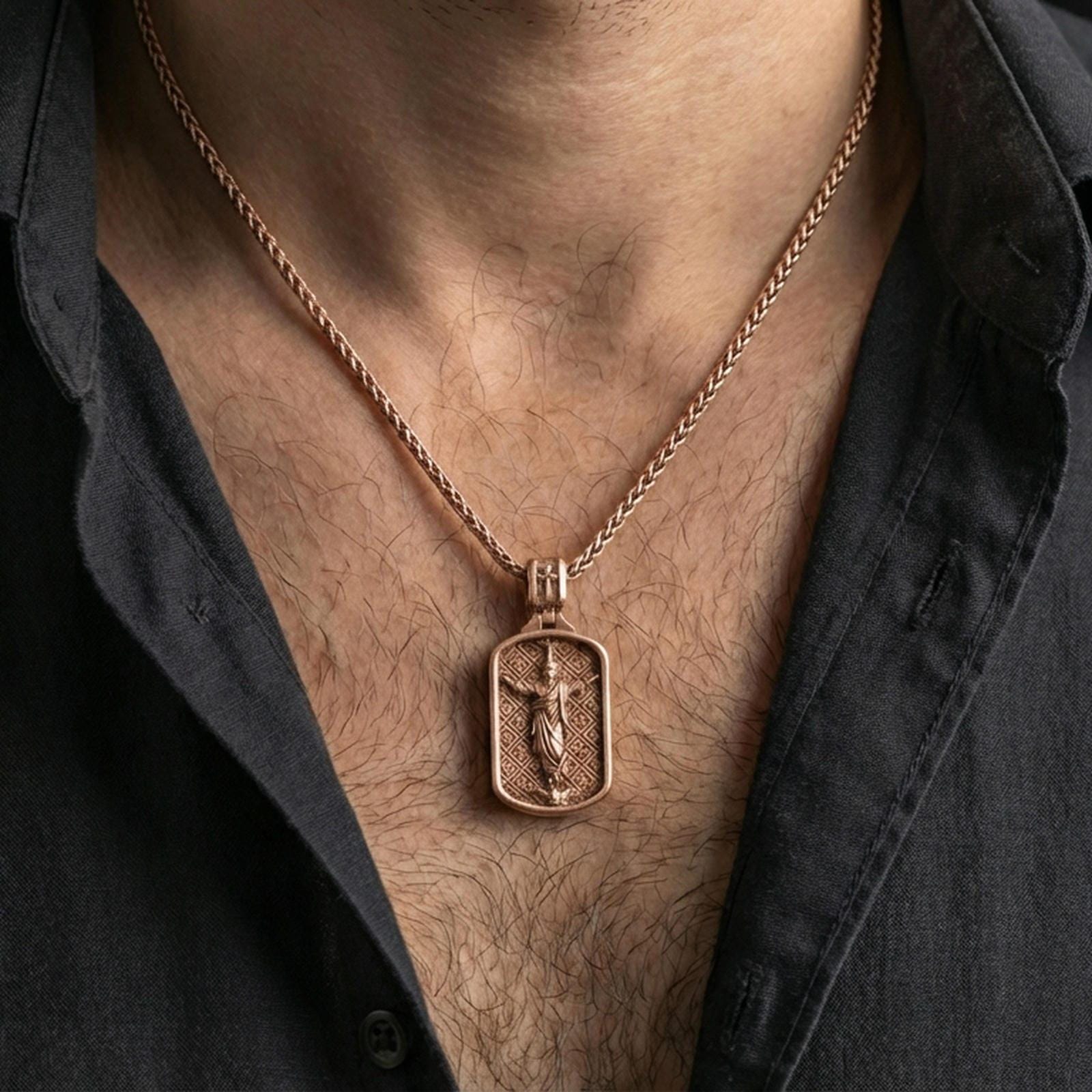 Rose gold plated Jesus pendant with framed sacred scene worn on the neck in a refined lifestyle shot with a warm and elegant presentation