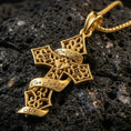 Load image into Gallery viewer, Gold plated gothic statement cross pendant with intricate scrollwork, scripted Only God Can Judge Me message, and framed cross design showcased on black volcanic rock in a refined macro jewelry image
