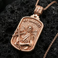 Load image into Gallery viewer, Rose gold plated Archangel Gabriel pendant with sacred angel figure, winged silhouette, and rounded rectangular frame resting on volcanic rock in an elegant close-up product presentation
