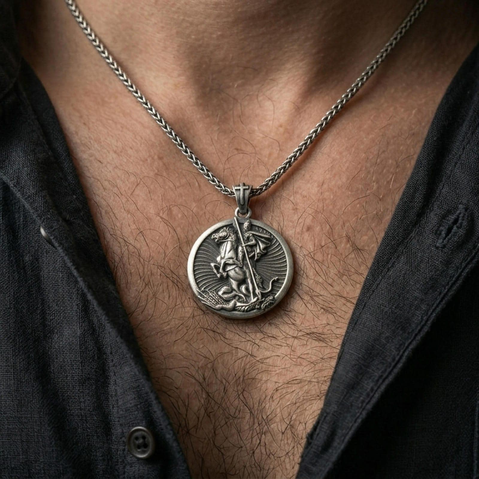 Oxidized Saint George pendant with mounted warrior design worn on the neck in a lifestyle jewelry shot, styled against the chest for a bold and symbolic look