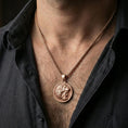 Load image into Gallery viewer, Rose gold plated Heracles lion helmet coin pendant necklace worn on the neck, lifestyle wear shot with elegant rosy shine and crisp Greek key border detailing visible.
