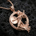 Load image into Gallery viewer, Rose gold plated Athena warrior pendant necklace on textured volcanic rock, centered studio-style close-up showcasing soft rosy glow and intricate Greek goddess armor-and-shield detailing.
