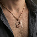 Load image into Gallery viewer, Rose gold plated Celtic raven knotwork pendant necklace worn on the neck, lifestyle wear shot with elegant rosy shine and crisp Celtic raven detailing visible.
