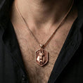 Load image into Gallery viewer, Rose gold plated Anubis pendant necklace worn on the neck, lifestyle wear shot with elegant rosy shine and crisp Anubis-and-skull detailing visible.
