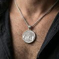 Load image into Gallery viewer, Polished silver Yggdrasil tree of life pendant necklace worn on the neck, clean lifestyle wear shot capturing bright shine and the detailed tree-and-wolves relief in natural light.
