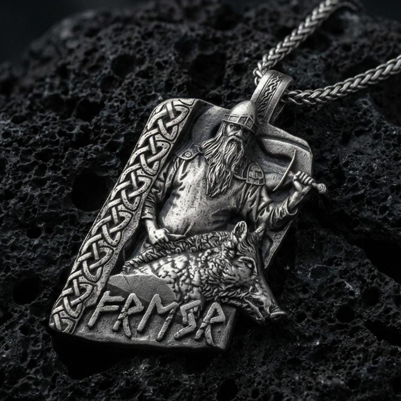 Oxidized Freyr and Gullinbursti pendant necklace on textured volcanic rock, centered close-up highlighting the Viking god relief, boar motif, rune lettering, and deep antique shadowed contrast.