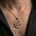 Load image into Gallery viewer, Rose gold plated Celtic triquetra pendant necklace worn on the neck, lifestyle wear shot with elegant rosy shine and crisp Celtic knot detailing visible.
