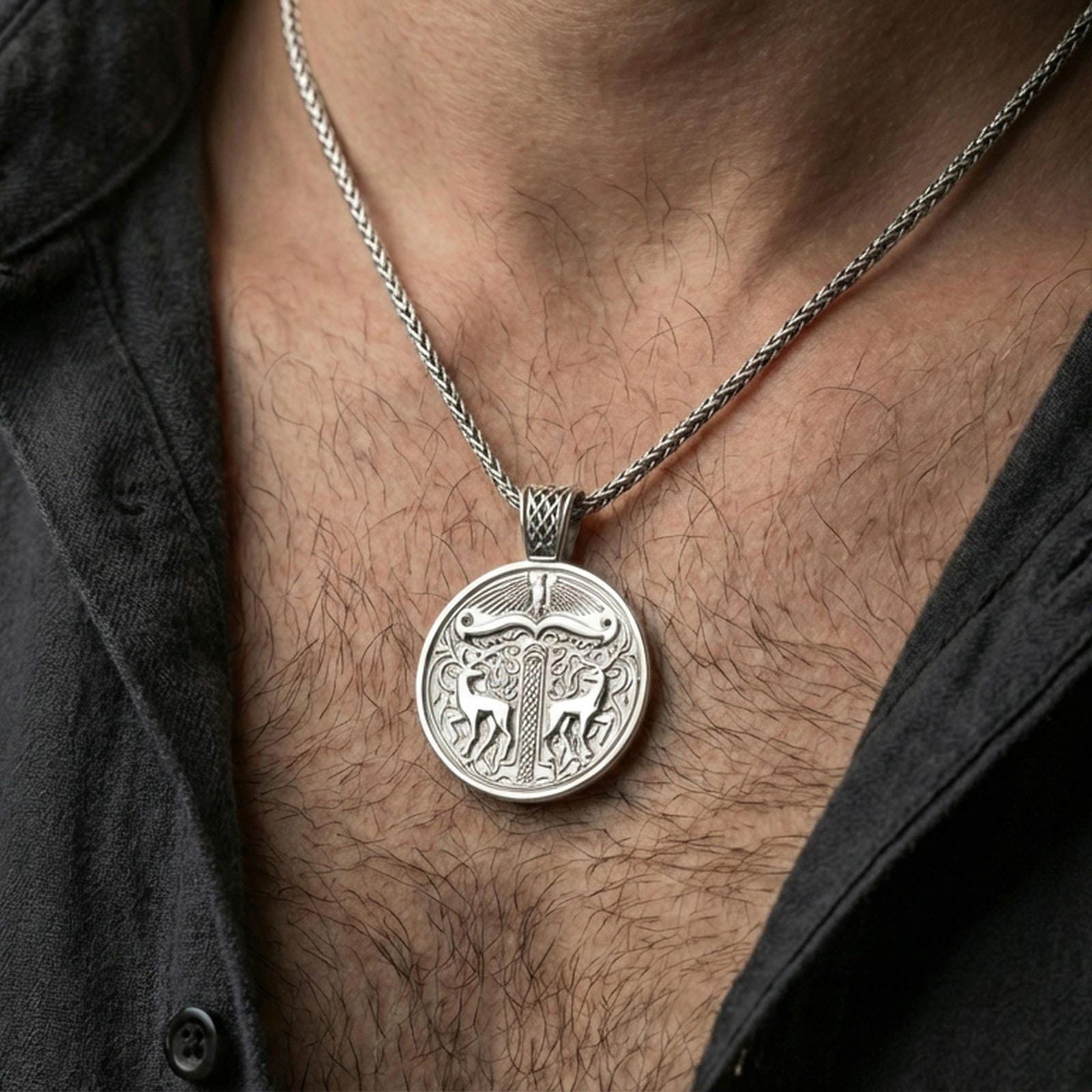 Polished silver Viking deer medallion pendant necklace worn on the neck, clean lifestyle wear shot capturing bright shine and the detailed stag-and-knotwork relief in natural light.