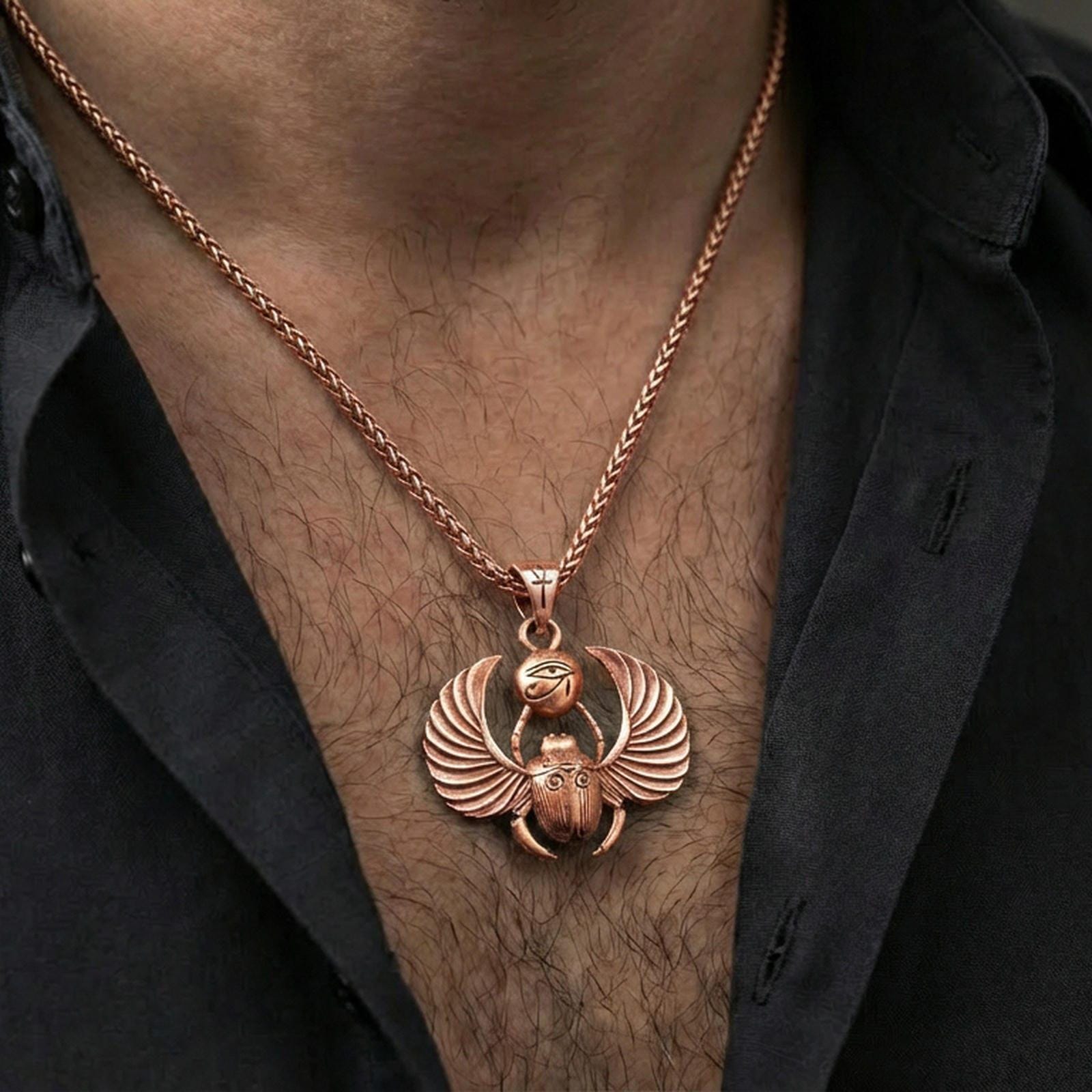 Rose gold plated winged scarab beetle pendant necklace worn on the neck, lifestyle wear shot with elegant rosy shine and crisp scarab-and-wing detailing visible.