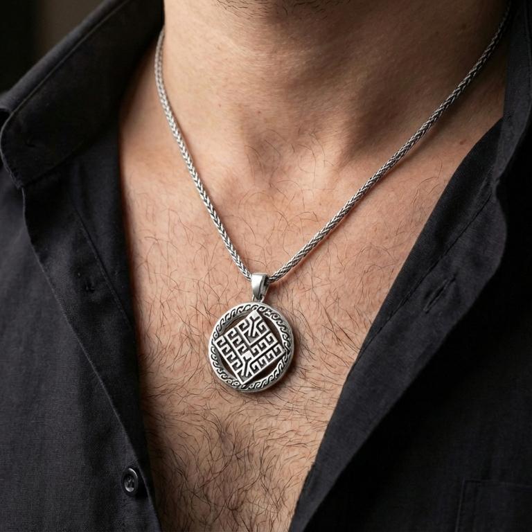 Polished silver geometric rune-style medallion pendant necklace worn on the neck, clean lifestyle wear shot capturing bright shine and the detailed labyrinth-like symbol in natural light.