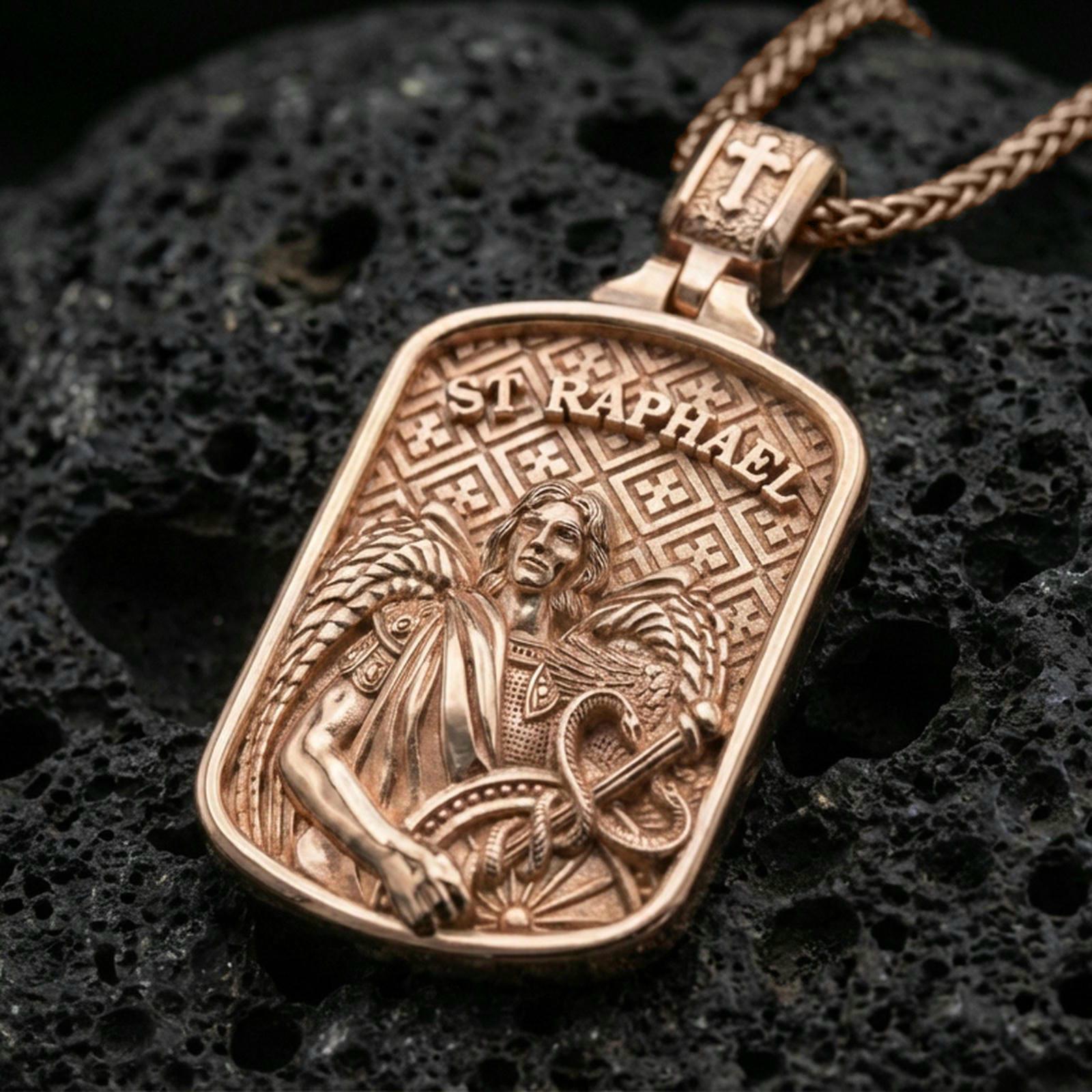 Rose gold plated St Raphael medal pendant on black volcanic stone, highlighting angel wings and sacred details.