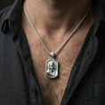 Load image into Gallery viewer, Polished silver Madonna medallion with serene sacred portrait worn on the neck in a close lifestyle frame, highlighting the draped veil and refined devotional detail
