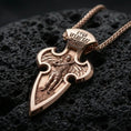 Load image into Gallery viewer, Rose gold plated Archangel Michael cross pendant with sacred warrior figure, elongated pointed silhouette, and detailed engraved top resting on volcanic rock in an elegant close-up product presentation
