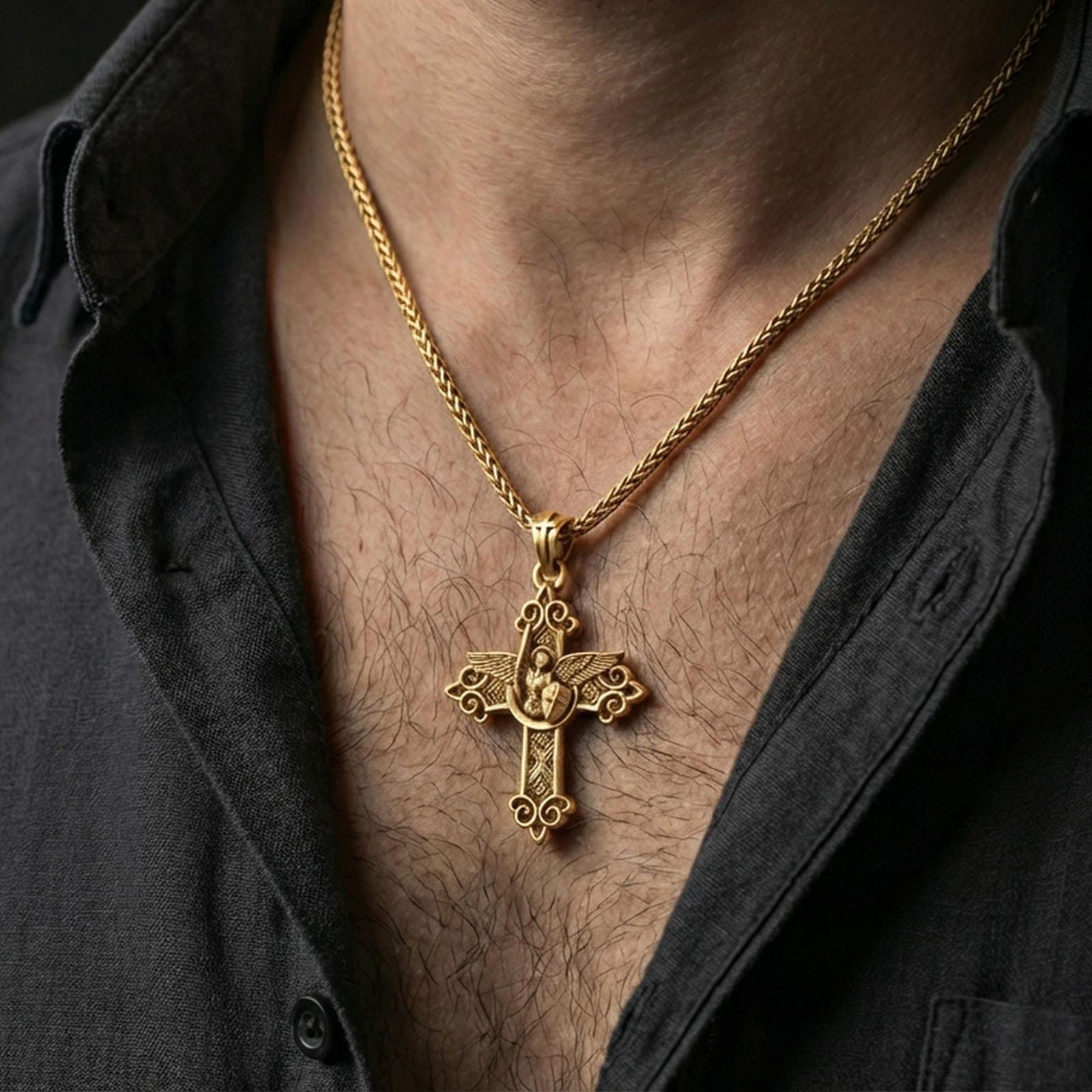 Gold plated Saint Michael necklace with winged protector motif and decorative cross form worn on the neck in a premium lifestyle composition with strong Christian jewelry styling
