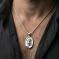 Load image into Gallery viewer, Polished silver Jesus medal with sacred portrait and crown of thorns worn on the neck in a close lifestyle frame, highlighting the refined facial relief and oval design
