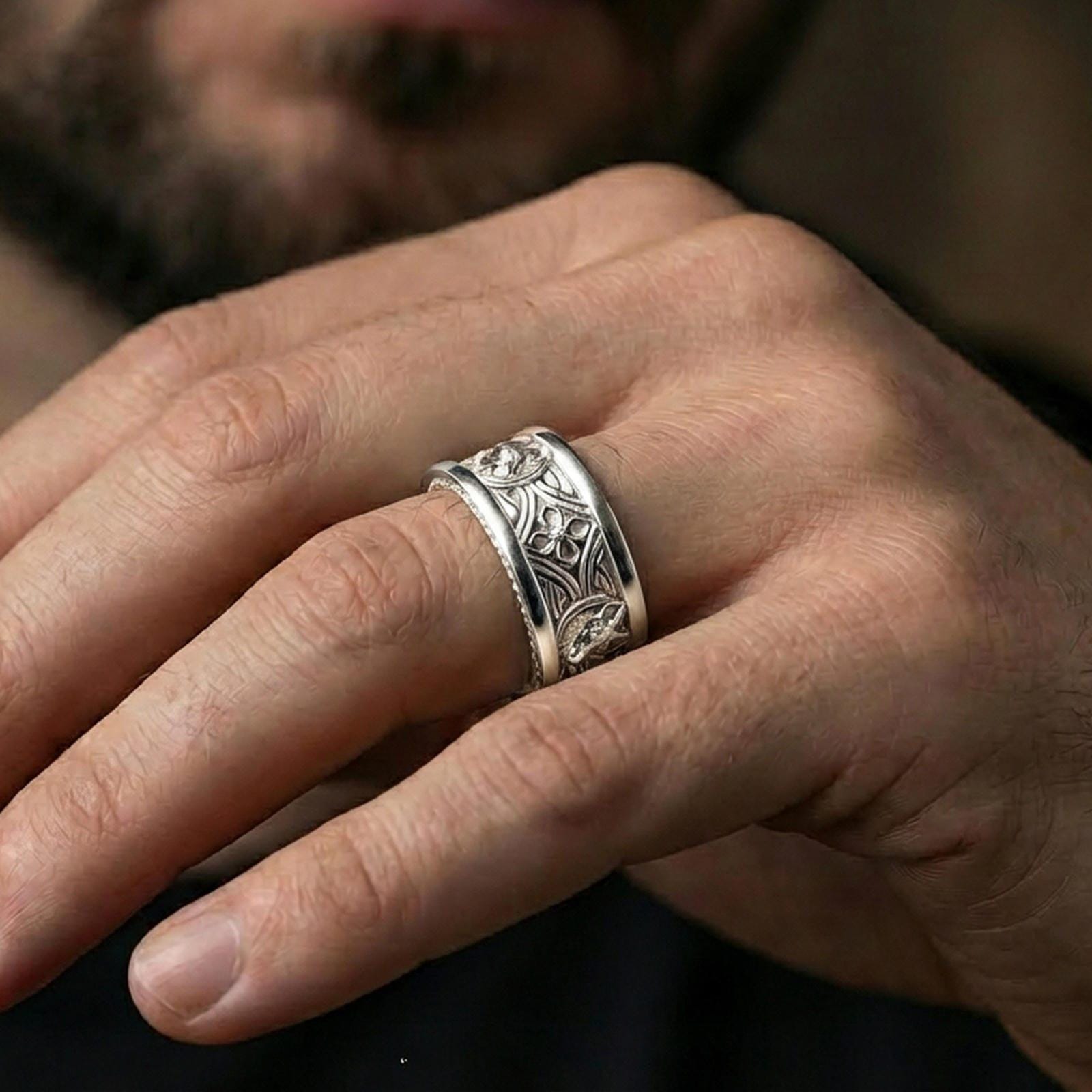 Polished silver fox band ring worn on a finger, clean lifestyle wear shot capturing bright shine and the detailed fox head relief in natural light.