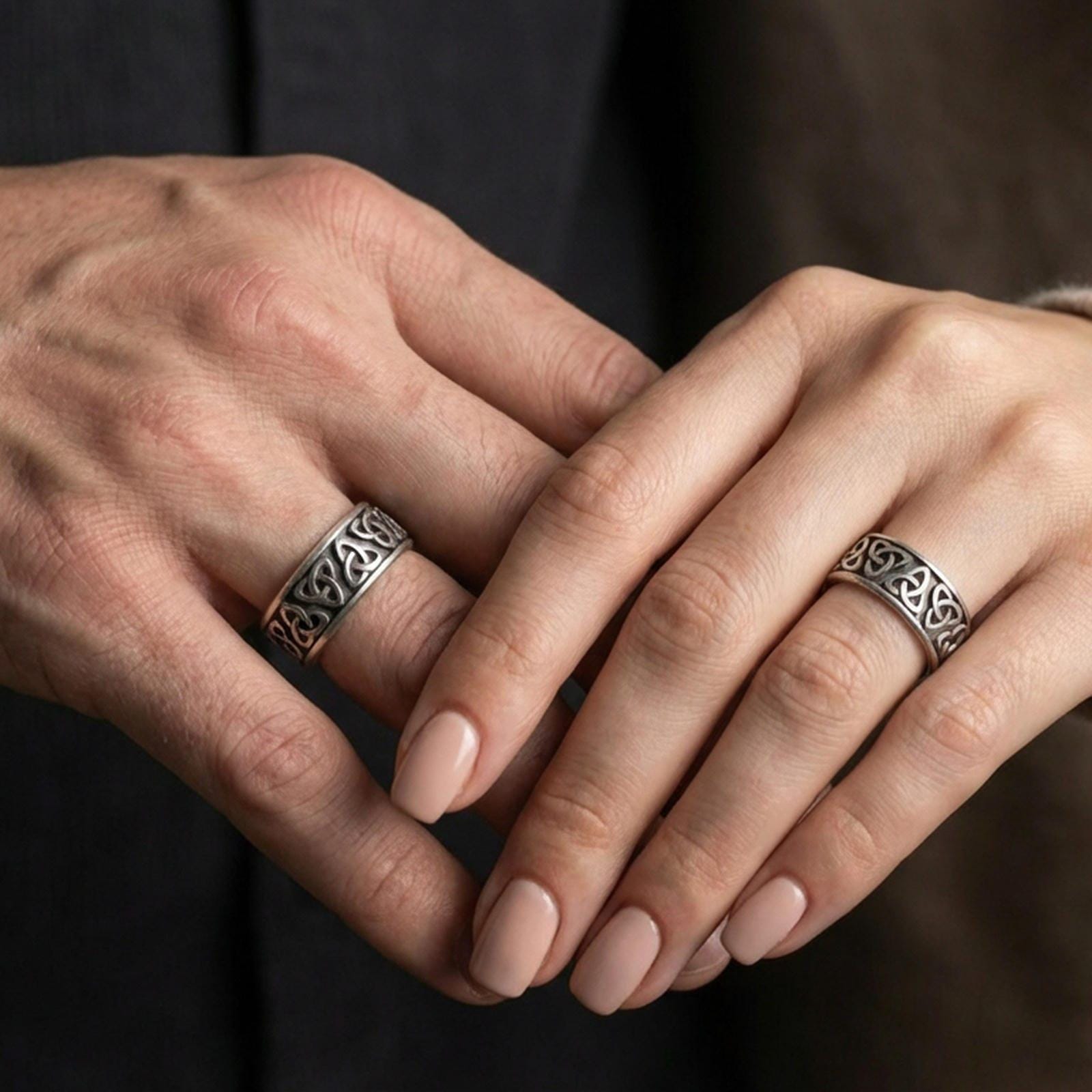 Oxidized Celtic triquetra band ring worn on a finger, lifestyle framing showing realistic scale and bold vintage contrast in a natural hand pose.