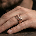 Load image into Gallery viewer, Rose gold plated twin lion band ring worn on a finger, lifestyle wear shot with elegant rosy shine and crisp lion detailing visible.
