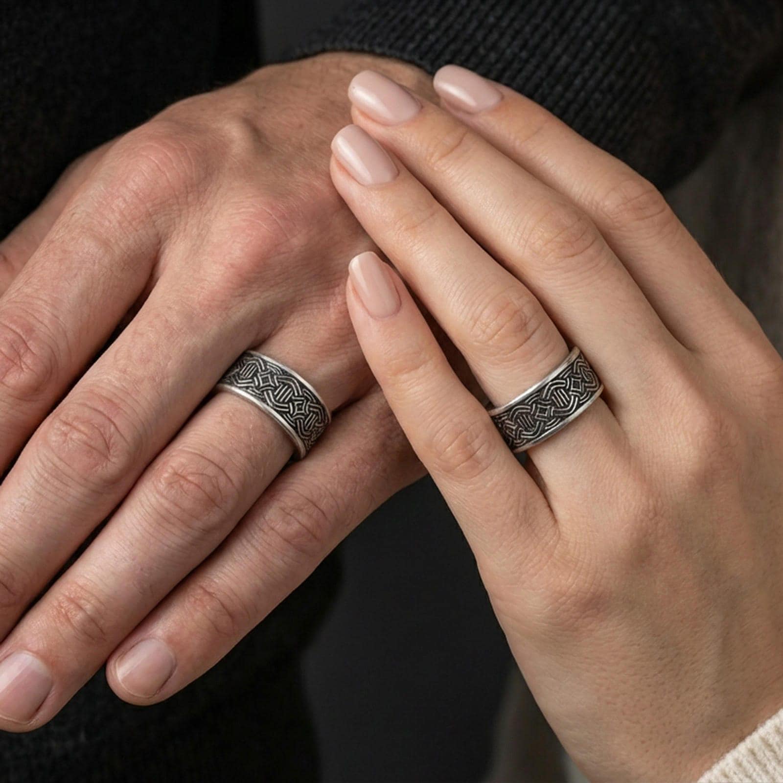 Oxidized geometric knotwork band ring worn on a finger, lifestyle framing showing realistic scale and bold vintage contrast in a natural hand pose.