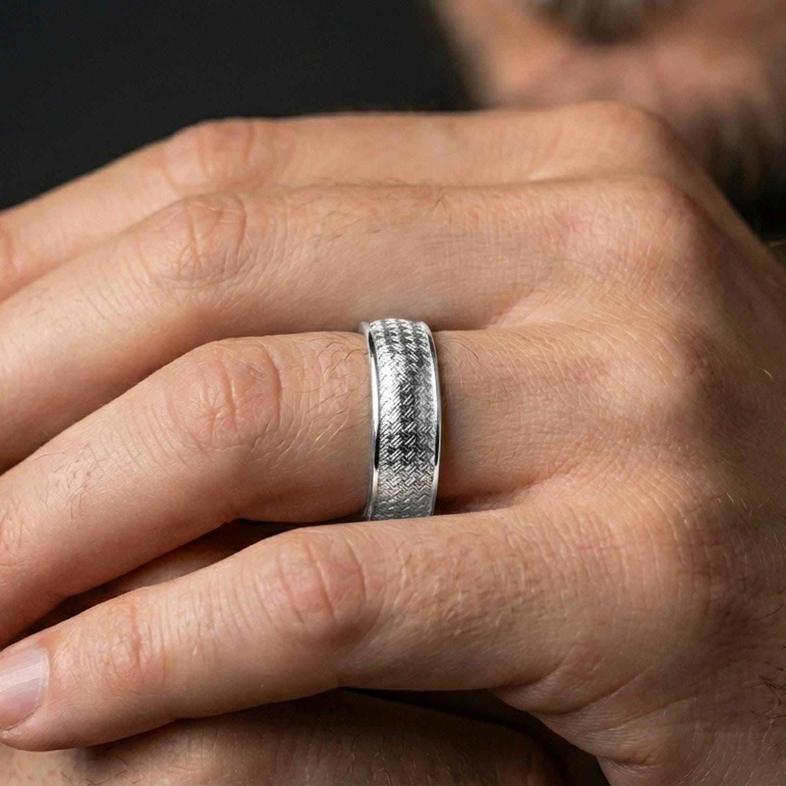 Polished silver woven texture band ring worn on a finger, lifestyle photo focusing on the bright finish, woven relief, and comfortable everyday profile.