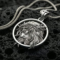 Load image into Gallery viewer, Polished silver Jesus medallion with circular frame, crown of thorns, and sculpted side profile placed on textured volcanic rock in a premium studio product shot
